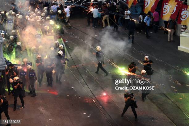 Protestors throw fireworks at Turkish riot policemen firing rubber bullets to disperse them during a demonstration on July 20,2015 in Istanbul...