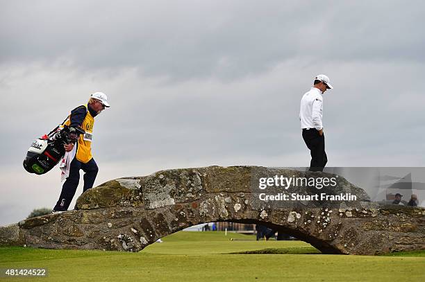 Zach Johnson of the United States and his caddie Damon Green walk over the Swilcan Bridge on the 18th hole in the playoff during the final round of...