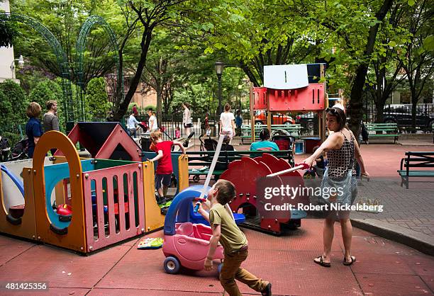 Families and children play in a park on the Long Island College Hospital campus June 19, 2015 in the Brooklyn borough of New York. The Fortis...