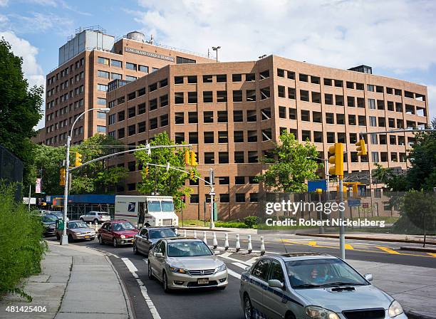 Traffic moves up the entrance ramp to the Brooklyn Queens Expressway adjacent to the Long Island College Hospital campus, center and right, June 19,...