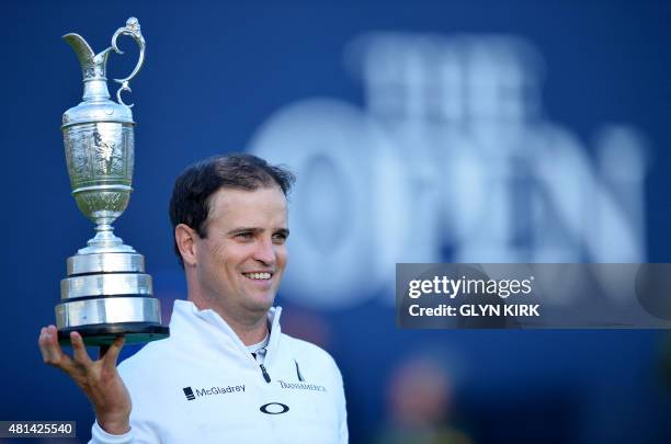 Golfer Zach Johnson poses for a photograph with the Claret Jug, the trophy for the Champion golfer of the year after winning the three-way playoff on...