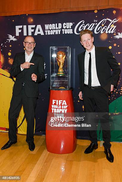 Peter Lohmeyer and Louis Klamroth pose with the trophy at the Gala Night of the FIFA World Cup Trophy Tour on March 29, 2014 in Berlin, Germany.