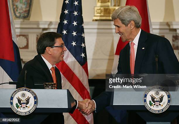 Secretary of State John Kerry and Cuba's Foreign Minister Bruno Rodriguez shake hands after a news conference at the State Department July 20, 2015...