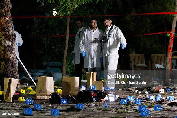 Forensic and police officers work at the site of a bomb attack on July 20, 2015 in Suruc, Turkey. At least 30 people were killed and around 100...