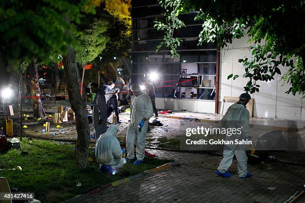 Forensic and police officers work at the site of a bomb attack on July 20, 2015 in Suruc, Turkey. At least 30 people were killed and around 100...