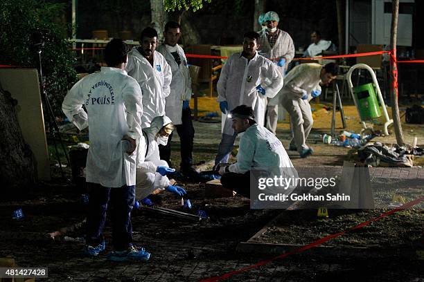 Forensic and police officers work at the site of a bomb attack on July 20, 2015 in Suruc, Turkey. At least 30 people were killed and around 100...