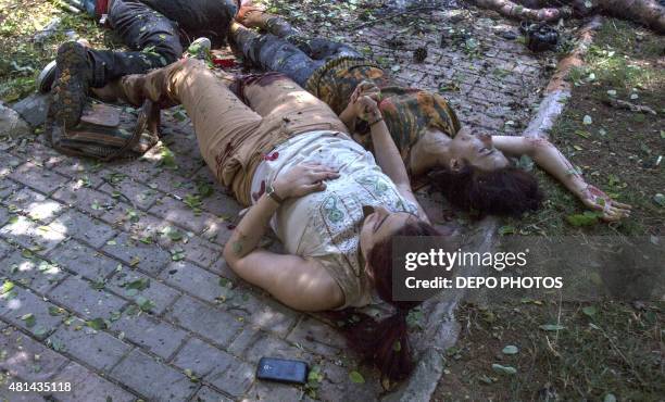 Two victims hold hands after an explosion in the town of Suruc in Sanliurfa, Turkey, on July 20 near the Syrian border. A suspected Islamic State...