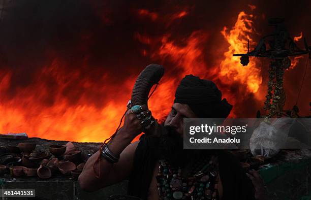 Pakistani devotee play traditional instrument front of fire at the shrine of Sufi saint Shah Hussain popularly known Madhu Lal Hussain on the 426th...