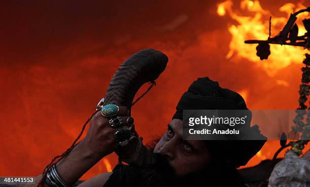 Pakistani devotee play traditional instrument front of fire at the shrine of Sufi saint Shah Hussain popularly known Madhu Lal Hussain on the 426th...