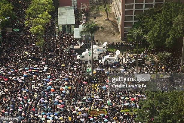 Trucks move through the crow while protesters attend the rally called by the student groups occupying the Legislature Yuan on March 30, 2014 in...