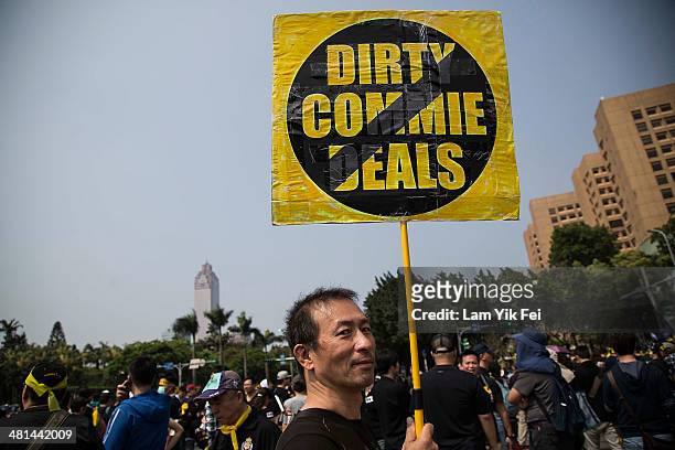Man holds a signs as protesters rally called by the student groups occupying the Legislature Yuan on March 30, 2014 in Taipei, Taiwan. Taiwanese...
