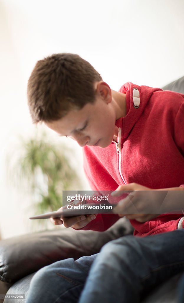 Boy intensly staring at tablet device