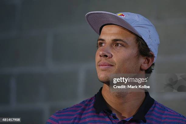 Australian surfers Julian Wilson looks on as Mick Fanning speaks to the media during a press conference at All Sorts Sports Factory on July 21, 2015...