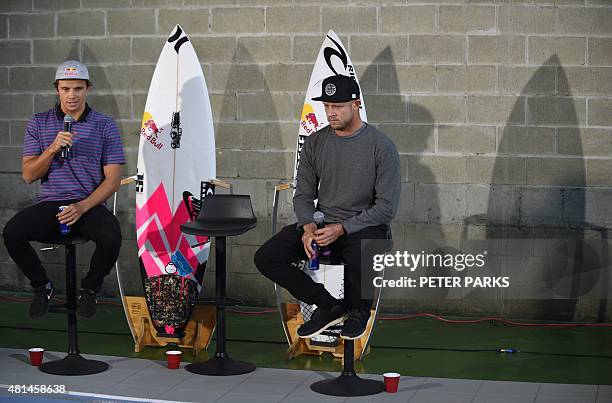 Australian surf champion Mick Fanning listens as his friend Julian Wilson recounts their close encounter with a shark at a press conference held in...