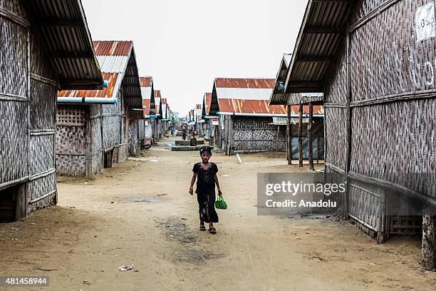 Young Rohingya girl dressed in new clothing to mark Eid-al-Fitr walks through the IDP camp in Sittwe, Rakhine State Myanmar on July 18 2015. An...