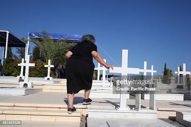 The sister of a dead soldier is walking on the monument of Timbou cemetery where the memorial of the people who died in the Turkish invasion in 1974...