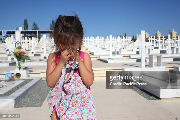 Girl is standing in Timbou cemetery in Nicosia, for the memorial day of people who died in the Turkish invasion in 1974. Cyprus marks 41 years since...