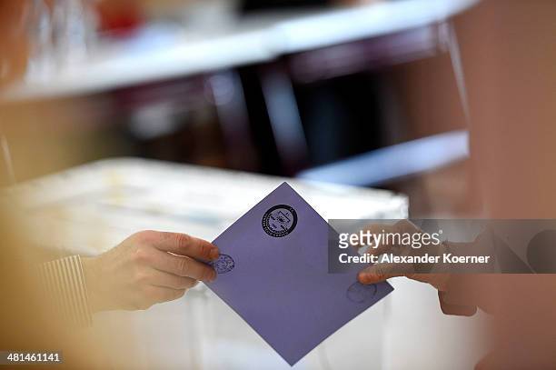 Local residents cast their vote for mayoral elections in the ballot boxes at Sait Ciftci School in the Sisli district of Istanbul, during the first...