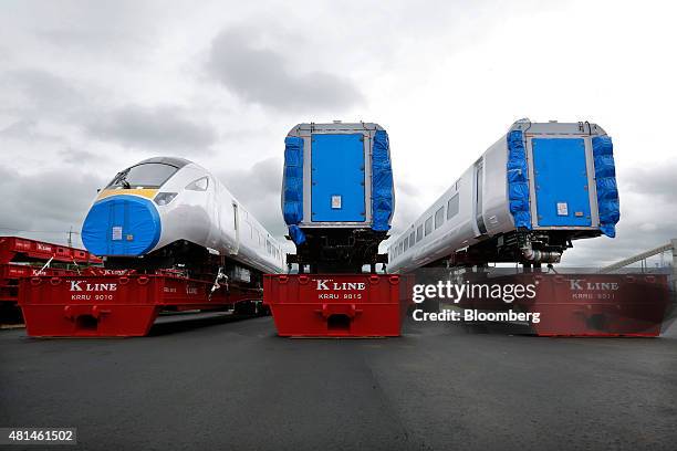 Class 800 Intercity Express train railcars, manufactured by Hitachi Ltd., sit as they wait to be loaded onto a roll-on/roll-off transporter vessel...