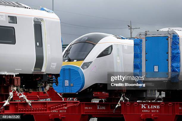 Class 800 Intercity Express train railcars, manufactured by Hitachi Ltd., sit as they wait to be loaded onto a roll-on/roll-off transporter vessel...