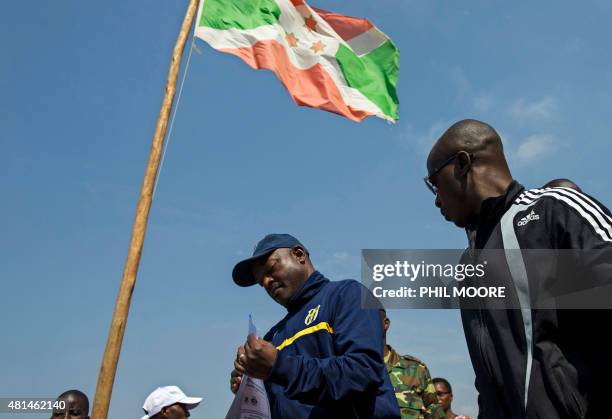 Incumbent Burundi President Pierre Nkurunziza lines up prior to casting his ballot at a polling station in his native village of Buye in Ngozi...