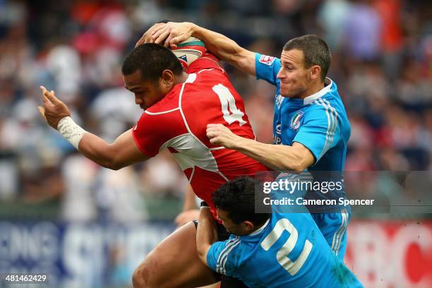 Phiva Lotoahea of Japan is tackled during the Qualifier final between Italy and Japan during the 2014 Hong Kong Sevens at Hong Kong International...