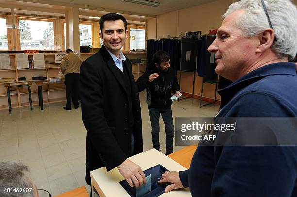 Xavier Bonnefont , French right-wing opposition Union for a Popular Movement candidate for the mayoral election in Angouleme, casts his ballot to...