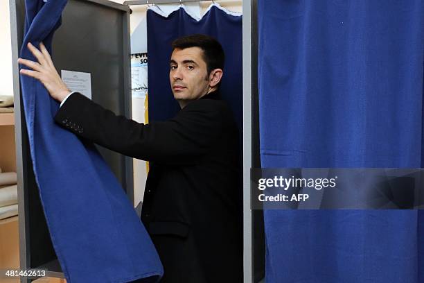 Xavier Bonnefont, French right-wing opposition Union for a Popular Movement candidate for the mayoral election in Angouleme, steps out of a polling...