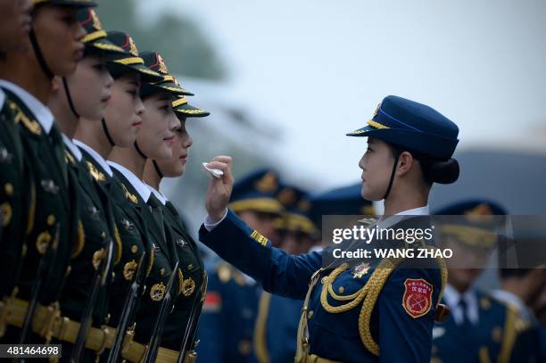 Chinese honour guards prepare for the arrival of New Zealand's Governor-General Jerry Mateparae and Chinese President Xi Jinping during a welcome...