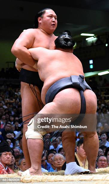 Toyonoshima pushes Mongolian wrestler Kyokutenho out of the ring to win during day nine of the Grand Sumo Nagoya Tournament at Aichi Prefecture...