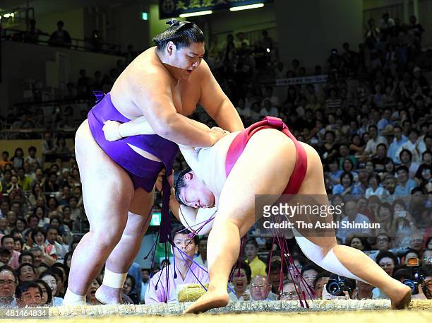 Endo pushes Sadanoumi out of the ring to win during day nine of the Grand Sumo Nagoya Tournament at Aichi Prefecture Gymnasium on July 20, 2015 in...