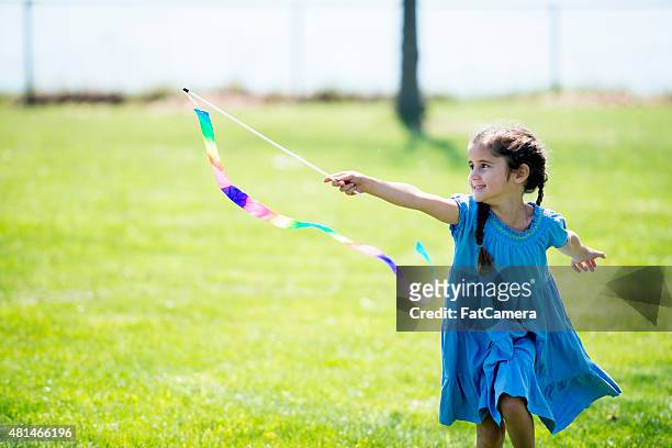 little girl with flag at park - blue dress stock pictures, royalty-free photos & images