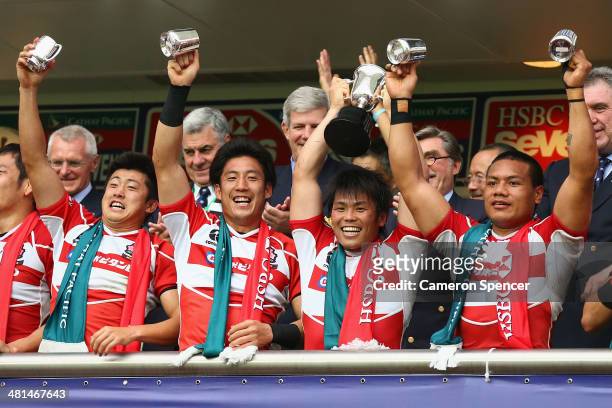 Japan captain Katsuyuki Sakai and team mates celebrate after winning the Qualifier final between Italy and Japan during the 2014 Hong Kong Sevens at...