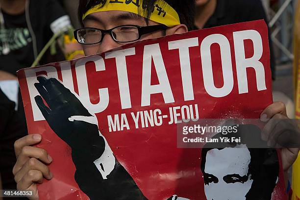 Protester holds up a sign as over two hundred thousand people rally on March 30, 2014 in Taipei, Taiwan. Taiwanese student protesters opposing the...