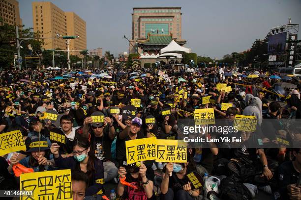 Protestors holds signs as over two hundred thousand people rally on March 30, 2014 in Taipei, Taiwan. Taiwanese student protesters opposing the...