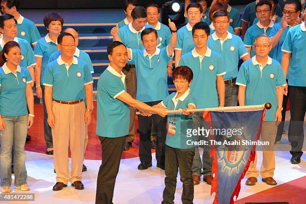 Ruling Kuomintang Party presidential election candidate Hung Hsiu-Chu receives a flag from the party chairman Eric Chu after being selected during...