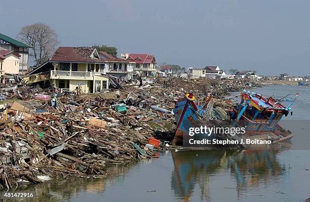 Damaged boat rests next to shore on the Sangai Kreung Aceh River in Banda Aceh Indonesia 150 miles from southern Asia's massive earthquake's...