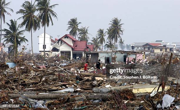 People walk through the rubble after the Dec 26th earthquake and Tsunami in Banda Aceh, Indonesia -150 miles from southern Asia's massive...