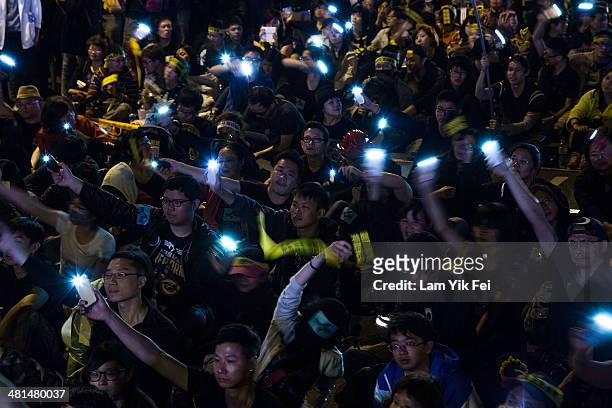 Protesters wave mobile phones as over two hundred thousand people rally on March 30, 2014 in Taipei, Taiwan. Taiwanese student protesters opposing...