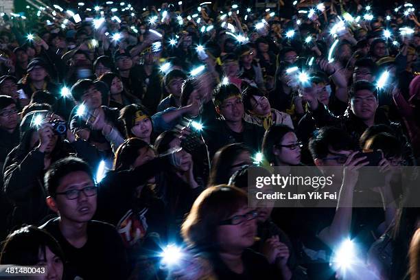 Protesters wave mobile phones as over two hundred thousand people rally on March 30, 2014 in Taipei, Taiwan. Taiwanese student protesters opposing...