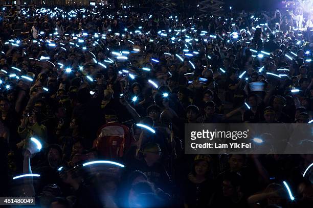Protesters wave mobile phones as over two hundred thousand people rally on March 30, 2014 in Taipei, Taiwan. Taiwanese student protesters opposing...