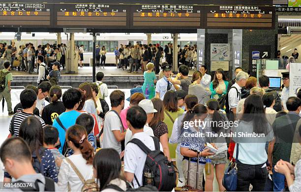Passengers wait for the service restart at Kyoto Station as the Typhoon Nangka hits Western Japan on July 18, 2015 in Kyoto, Japan. Japan...