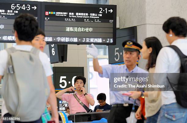 Passengers wait for the service restart at Osaka Station as the Typhoon Nangka hits Western Japan on July 18, 2015 in Osaka, Japan. Japan...