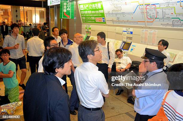 Passengers wait for the service restart at Takarazuka Station as the Typhoon Nangka hits Western Japan on July 18, 2015 in Takarazuka, Hyogo, Japan....