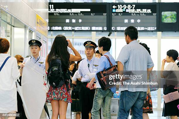 Passengers wait for the service restart at Osaka Station as the Typhoon Nangka hits Western Japan on July 18, 2015 in Osaka, Japan. Japan...