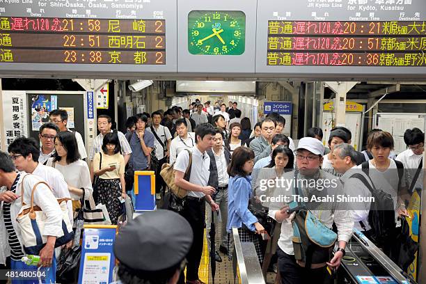 Passengers wait for the service restart at Yamazaki Station as the Typhoon Nangka hits Western Japan on July 18, 2015 in Oyamazaki, Kyoto, Japan....