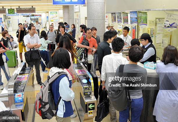Passengers wait for the service restart at Takatsuki Station as the Typhoon Nangka hits Western Japan on July 18, 2015 in Takatsuki, Osaka, Japan....