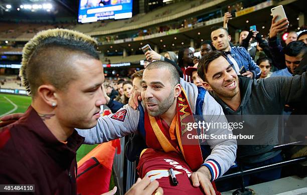 An AS Roma supporter thanks Radja Nainggolan of AS Roma after Nainggolan signed his shirt during the International Champions Cup match between...