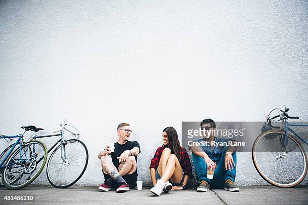 city friends with bikes and coffee - european outdoor urban walls stockfoto's en -beelden