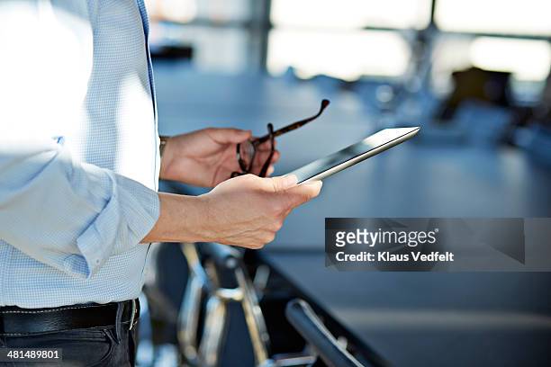 hands holding tablet & a pair of glasses - hands holding tablet a pair of glasses stock pictures, royalty-free photos & images